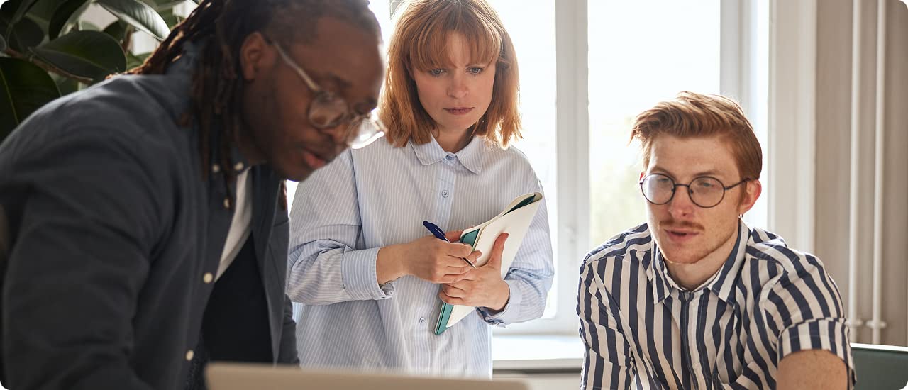 Workers looking at a computer screen in an office