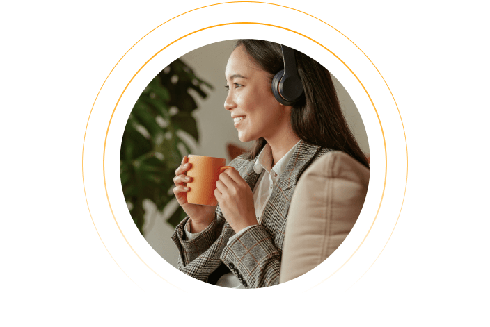 Photo of an employee fitting some listening time in during their coffee break.