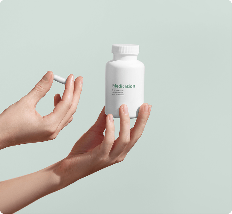 two hands holding a capsule of medication and a medication bottle