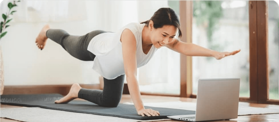 A woman exercising by doing yoga.