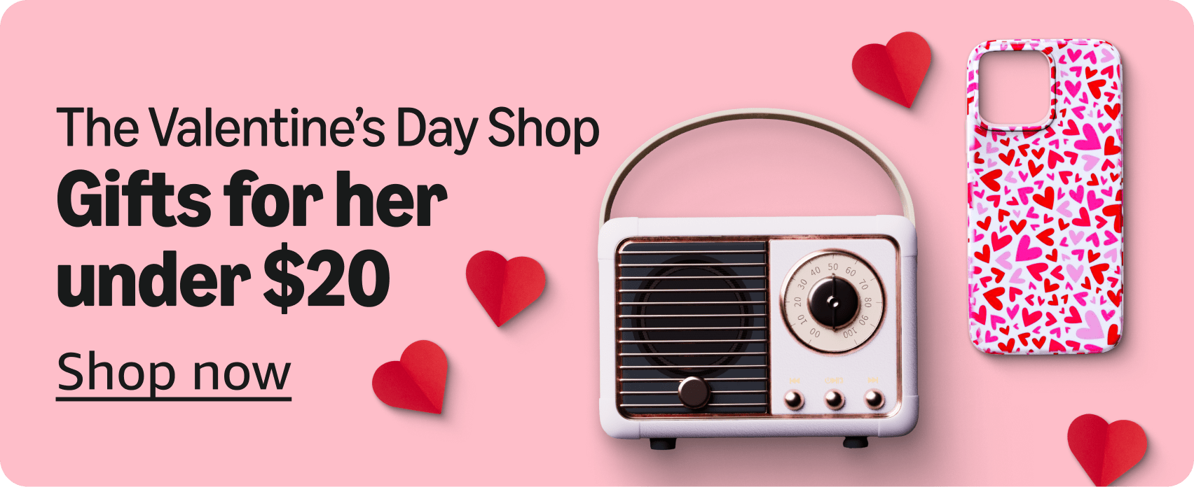 A banner image reading The Valentine's Day Shop, gifts for her under $20, shop now on baby pink background along with a pink and red hearted iphone case and a retro looking stereo speaker.