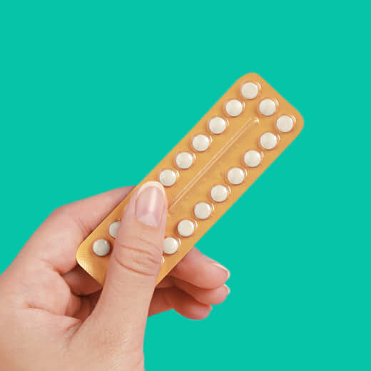 Female hand holds birth control pill pack from Amazon Pharmacy