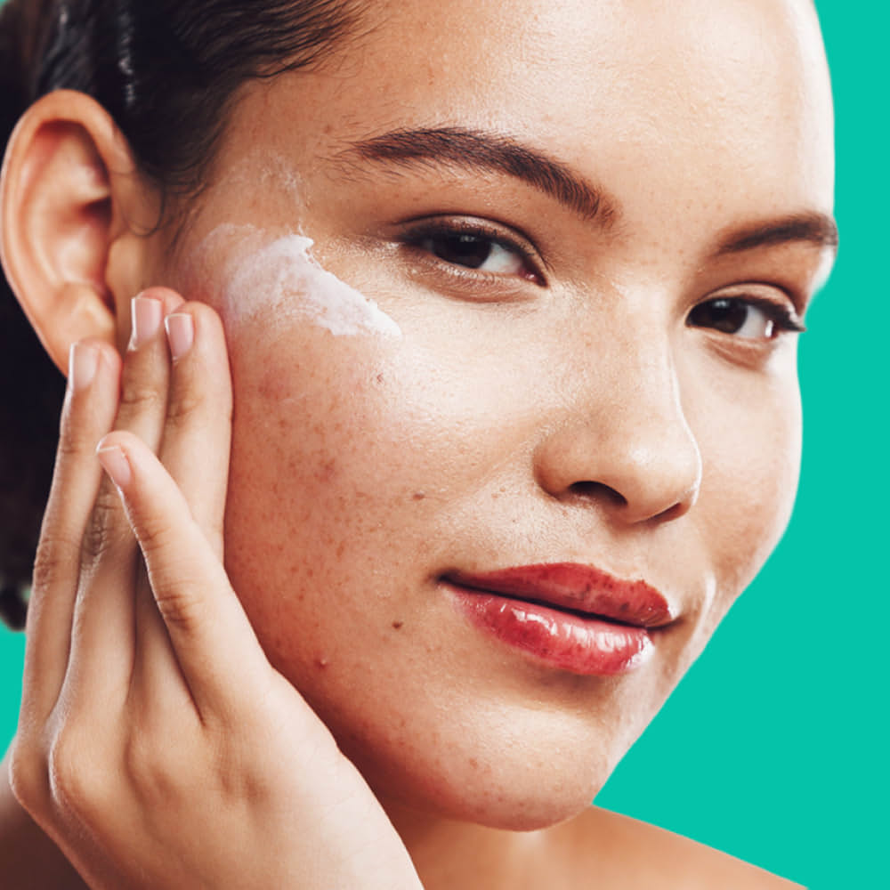 Amazon One Medical Dark Spot and Melasma Treatment Woman applies prescription dark spot remover to her face