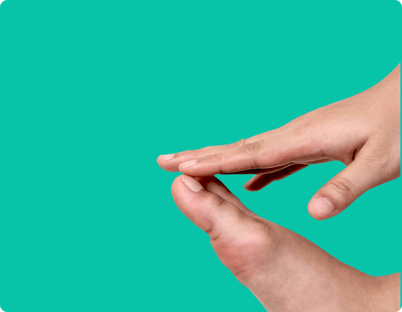 Amazon One Medical Toenail Fungus Treatment & Symptoms A hand touching a toe, inspecting it for any toenail fungus (onychomycosis) symptoms