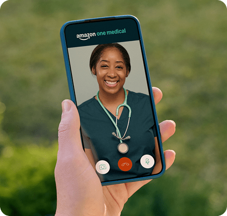 Online doctor smiles from photo during Amazon One Medical telehealth visit