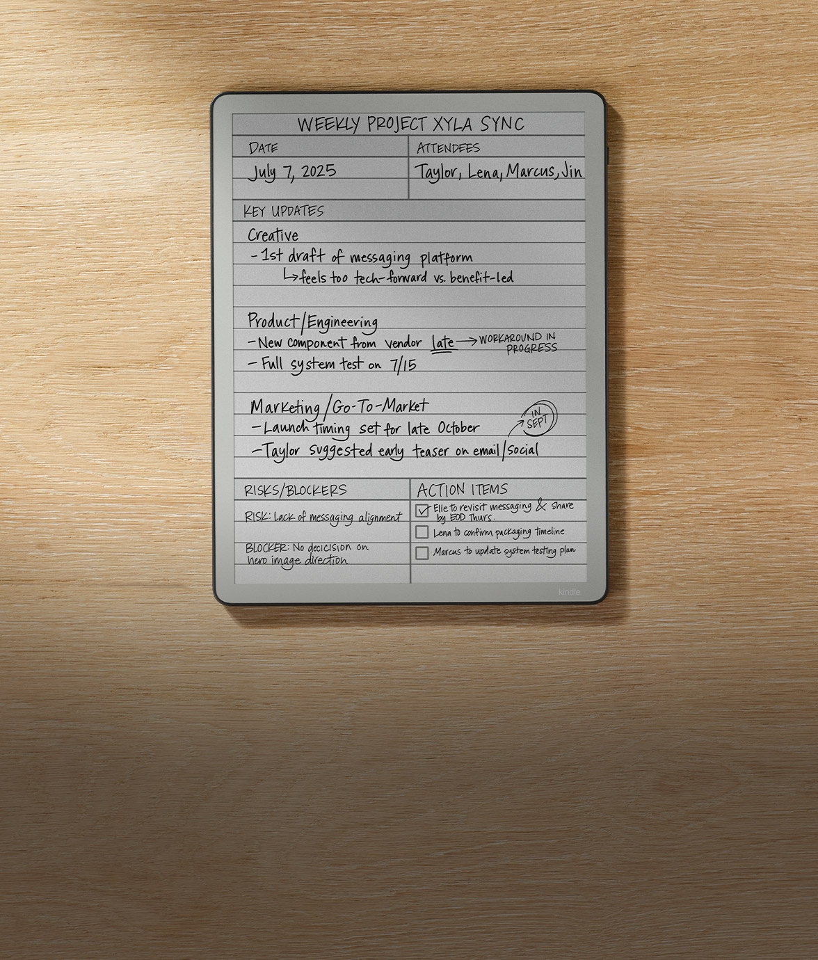 Kindle Scribe without front light on a wooden desk displaying a weekly project agenda with black handwritten updates and action items.