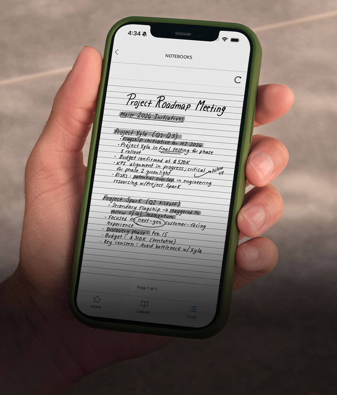 Hand holding a smartphone with the Kindle app open, showing a notebook page with handwritten notes from Kindle Scribe without front light.