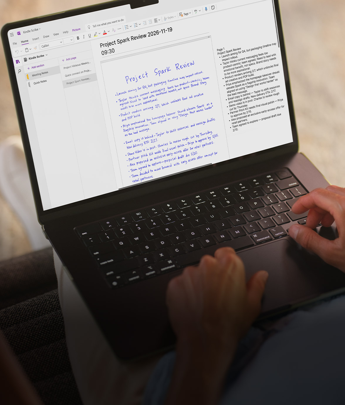 Laptop screen open to Microsoft OneNote with a Kindle Scribe notebook titled “Project Spark Review.” Blue handwritten notes show on the left, typed notes on the right. A person’s hands rest on keyboard.