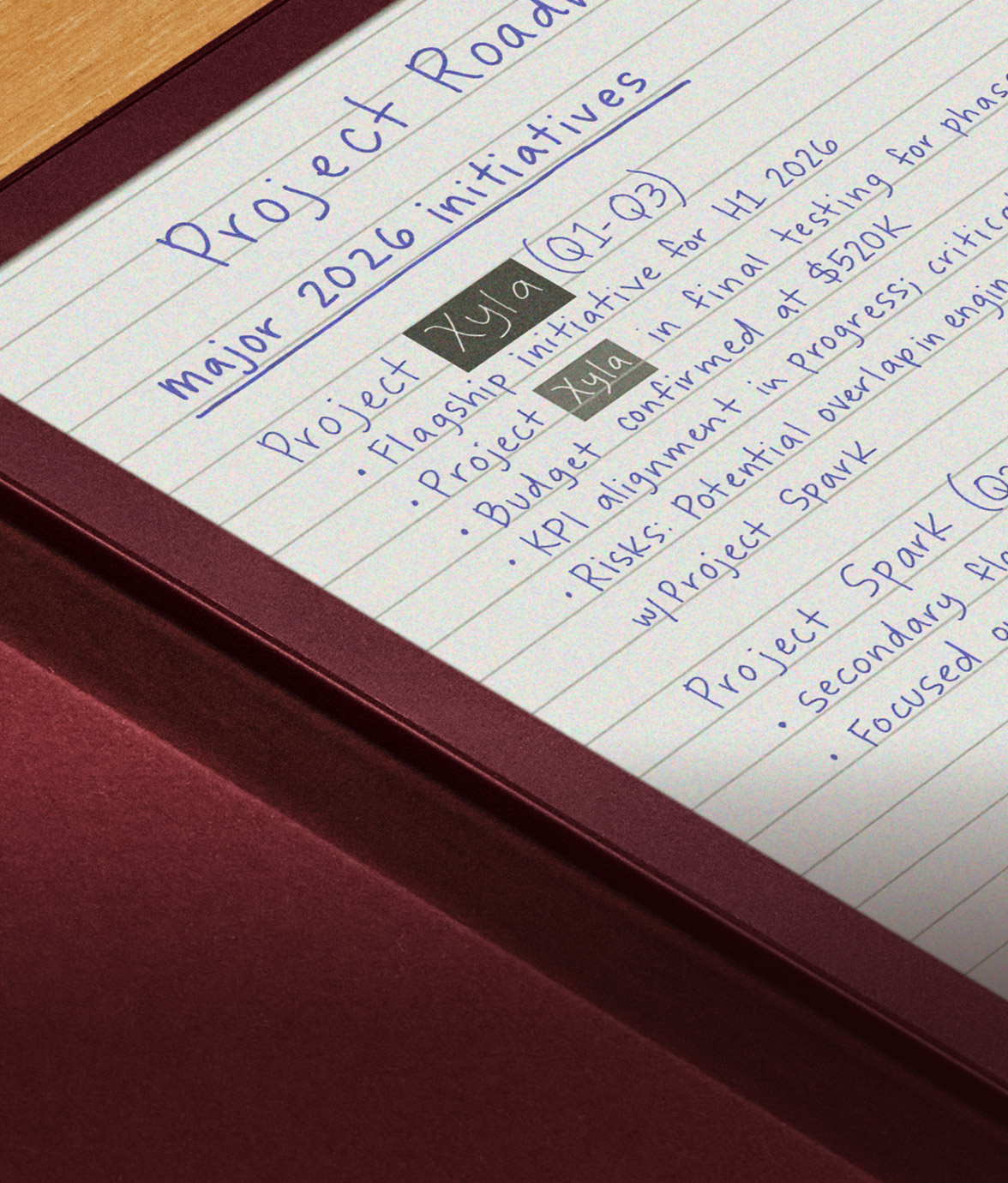 Close-up of Kindle Scribe Colorsoft screen with handwritten notes titled “Project Roadmap.” The page lists 2026 initiatives under “Project Xyla,” including budget confirmation, KPI alignment, and risks, written in blue ink with gray highlights.