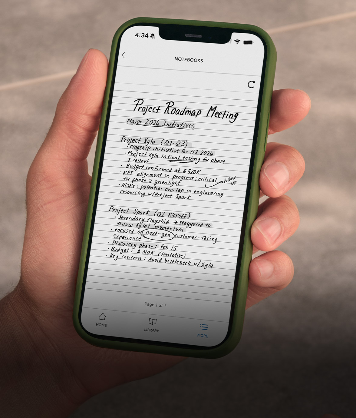 A person holding a smartphone with the Kindle app open, displaying handwritten project meeting notes synced from Kindle Scribe.
