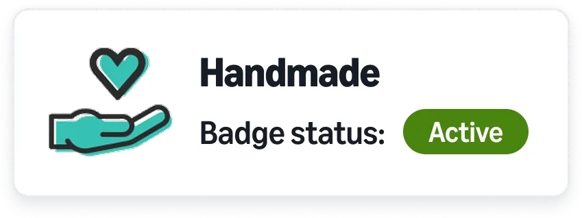 Artisan looking at laptop holding a ceramic bowl with a Handmade badge