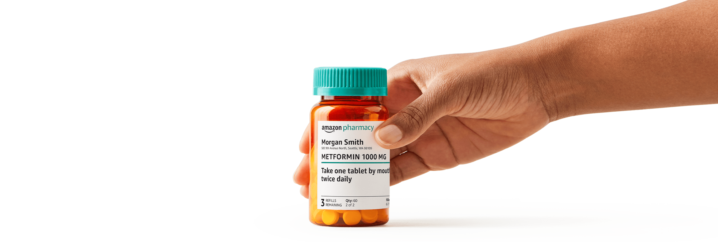 hand holding Amazon Pharmacy prescription bottle