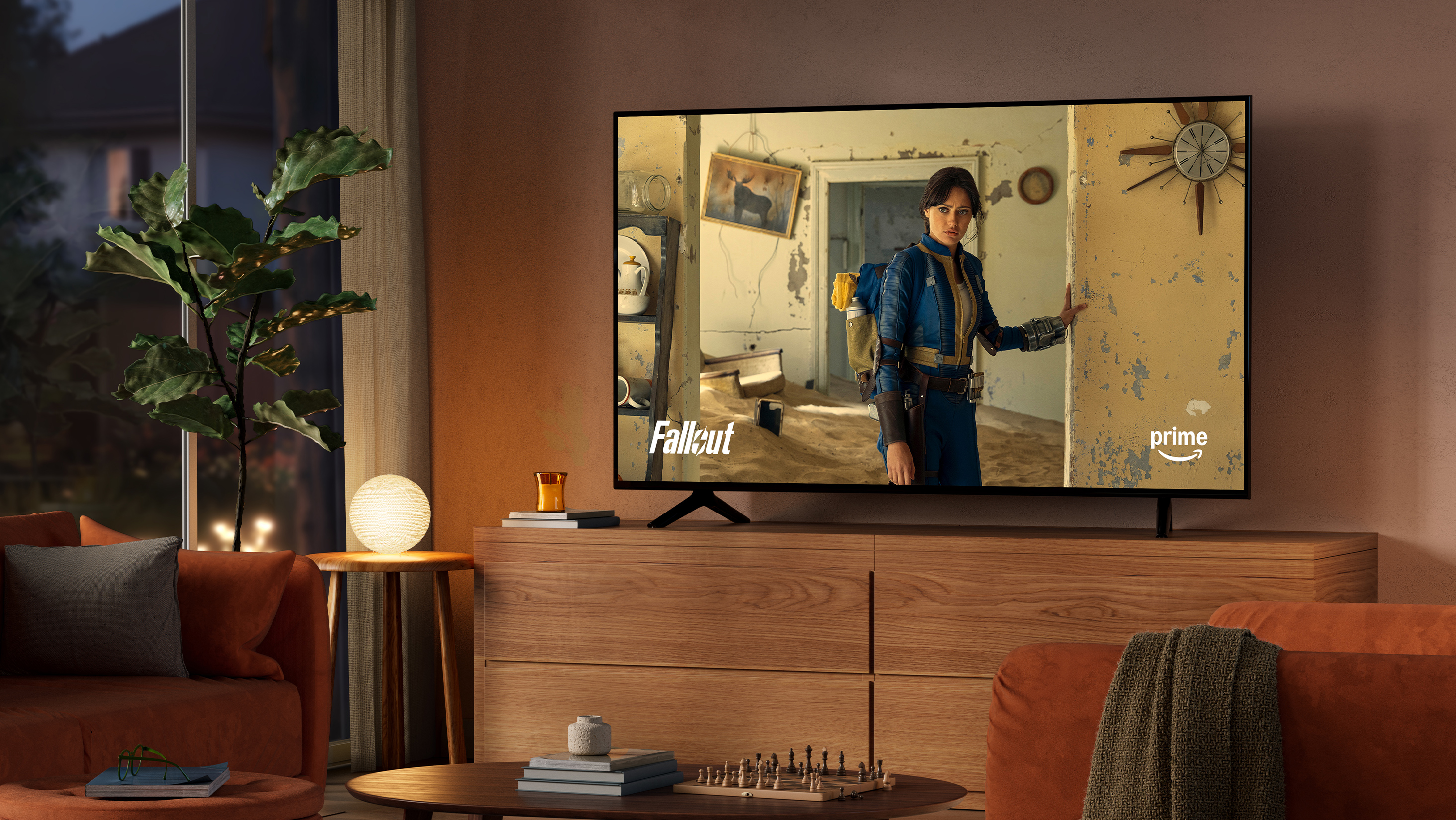 A dimly lit living room at night with the TV on an entertainment console. Fallout is on screen.