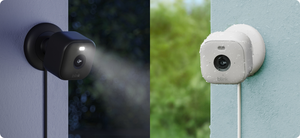 On the left, a black Mini 2 home security camera mounted outside with the built-in spotlight on at dusk. On the right, a white Blink Mini 2 home security camera mounted outside in the rain.