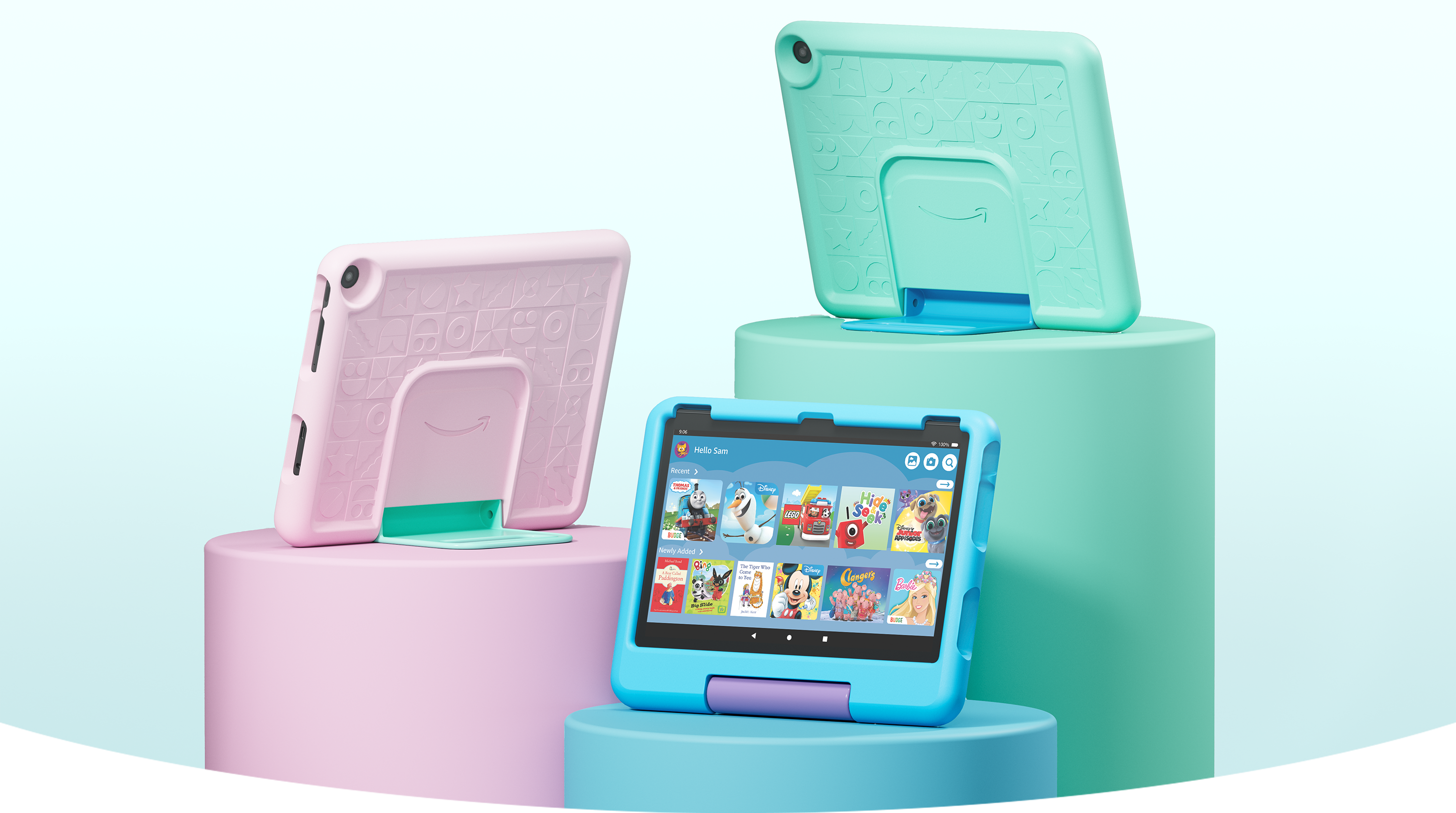Three Fire HD 10 Kids tablets on pedestals of varying heights showcasing the colour options (from left to right): pink, blue and light blue with Disney princesses.
