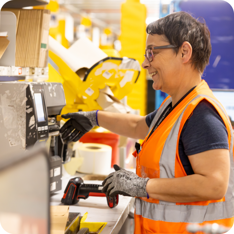 Warehouse associate working at packing station in fulfillment center
