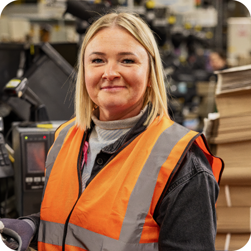 Warehouse associate working at packing station in fulfillment center