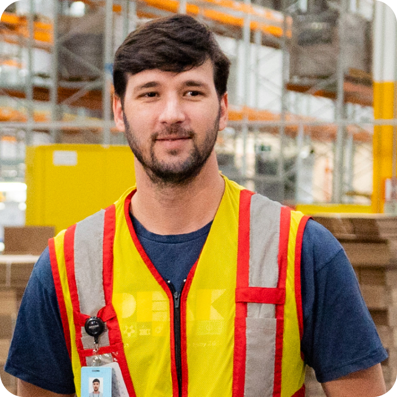 Associate in safety vest with ID badge at fulfillment center