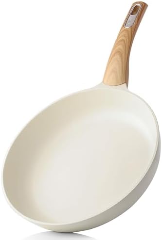 Small white ceramic frying pan with a wood-grain effect handle on a plain background