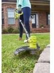 Person using Ryobi P2080 to edge a lawn