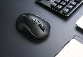 DAREU LM115G Wireless Optical Mouse on a desk next to a keyboard.