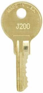Close-up of a brass replacement key with a code on its head.