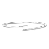Sterling silver, diamond for women. 0.15 ct. t.w. diamond. 3/16" wide. Clasp-free for easy, comfortable styling. Brilliant cut round diamond. Polished sterling silver. Due to the naturally occurring characteristics of diamonds, each is unique and may...