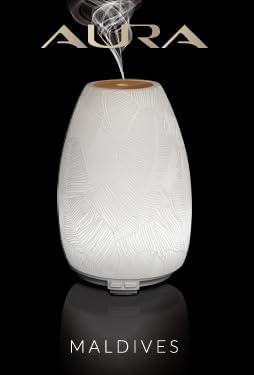 AURA Maldives Ultrasonic Diffuser with the AURA logo above it, emitting mist.