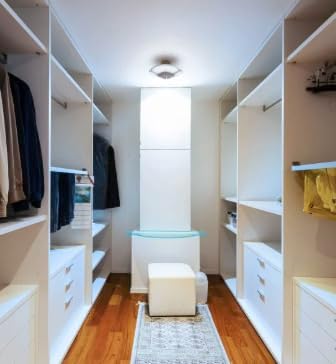 The Enbrighten LED Utility Light installed in a walk-in closet, illuminating the space.