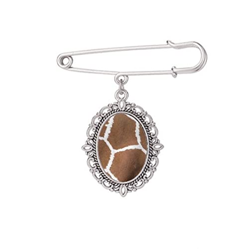 Broche plume de girafe M accessoire idéal pour sublimer un châle en soirée