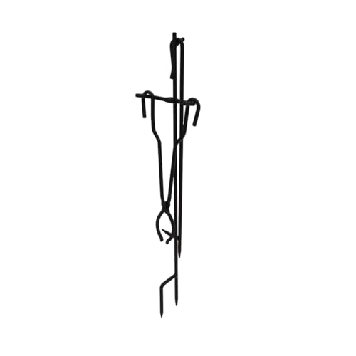 black steel fire poker and tongs standing upright in a matching stand next to a fire pit