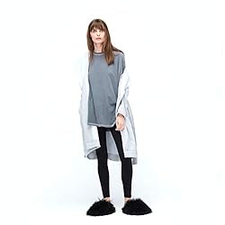 Woman wearing a white comfy robe with tie.