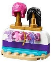 LEGO Friends hair wig display stand with pink and black wigs.