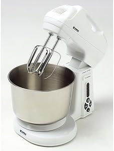 Kenmore stand mixer with beaters attached, positioned over a stainless steel mixing bowl on its base.