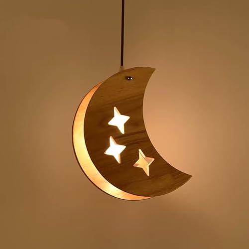 Lustre 3 lumières étoile et lune suspendu au-dessus de la table à manger