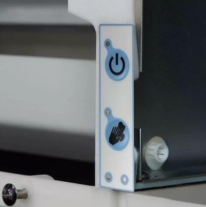 Close-up of the ice maker's control panel with power and cleaning buttons.
