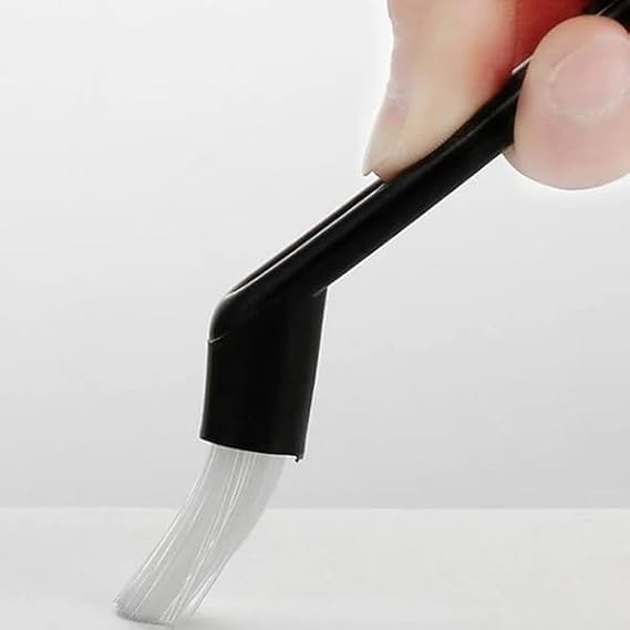 Hand holding Budan Cleaning Brush, showing its inclined head for sweeping
