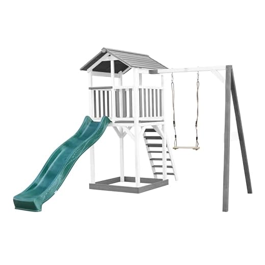 AXI Beach Tower Spielturm aus Holz in Weiß & Grau | Spielhaus für Kinder mit grüner Rutsche, Schaukel und Sandkasten | Stelzenhaus für den Garten