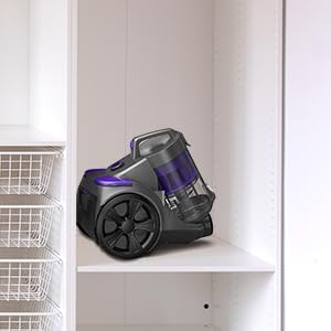 Canister vacuum cleaner in use on hard floors cleaning