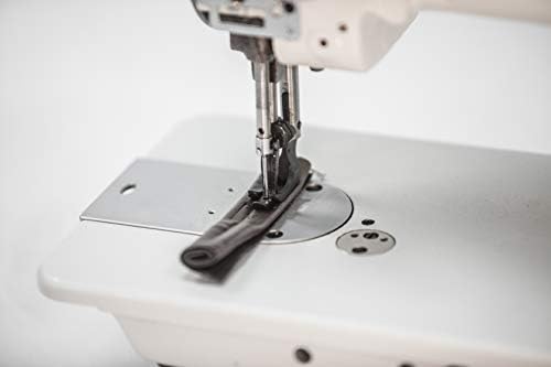 Close-up of the needle and walking foot mechanism on the sewing machine