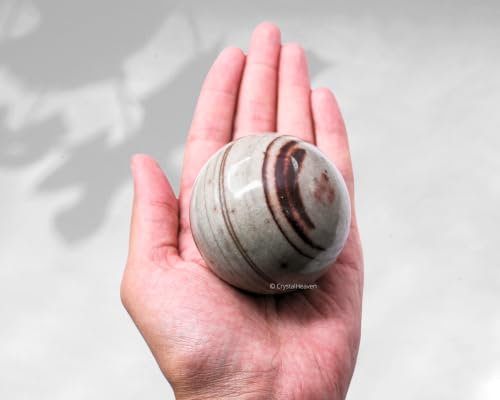 Image of Certified Narmada Shiva Lingam Crystal Ball for Meditation - Premium Crystal Vastu Items for Home and Feng Shui Items for Good Luck - Ideal for Pooja Supplies and Spiritual Practices (2.5 inch Inch)