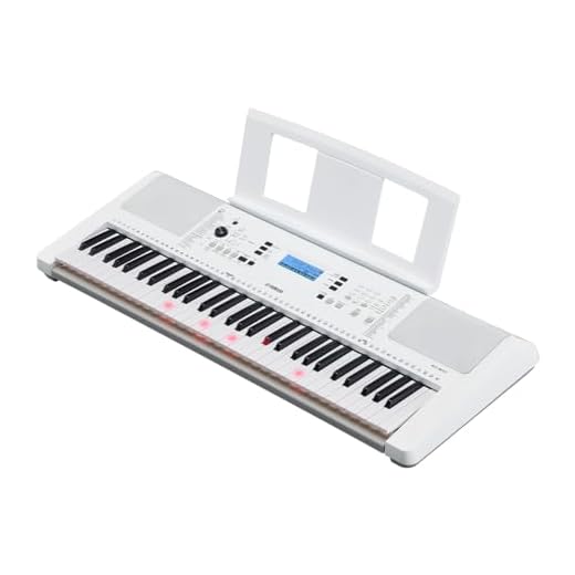 Yamaha Teclado portátil EZ300 de 61 teclas con teclas iluminadas y adaptador de corriente PA130