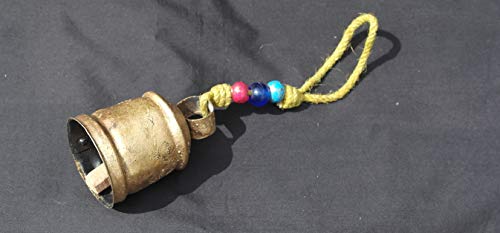 Traditional Swiss golden cow bell with rope and decorative beards
