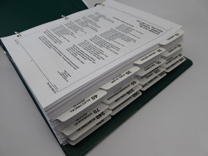 Ring-bound John Deere service manual with section dividers
