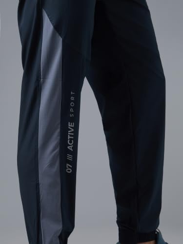 Image of TECHNOSPORT Men's Regular Fit Joggers with Zip Pockets, TECHNOLITE Quick Dry Stretchable Lightweight Track Pants for Gym Running and Casual Wear