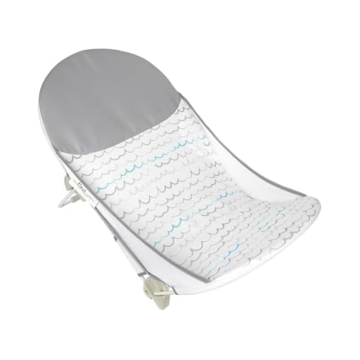 The First Years Sure Comfort Folding Baby Bather - Foldable Baby Bath Seat and Lounger for Home or On the Go - for Sink or Tub Use - Non-Slip Seat - For Up to 15 Lbs
