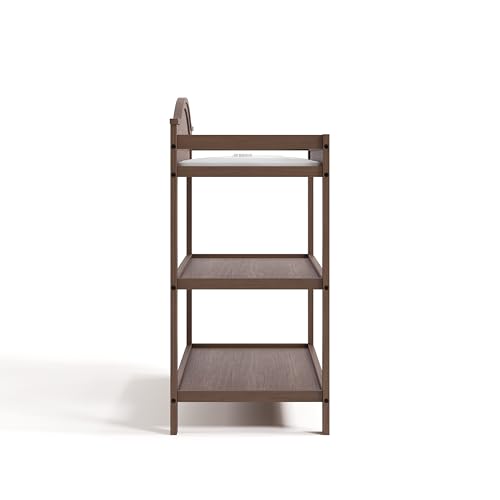 Image of Graco Story Changing Table with Water-Resistant Pad - GREENGUARD Gold Certified Baby Changing Station with Safety Strap, 2 Open Shelves, and a Nursery Must-Have Design (Hazelnut)