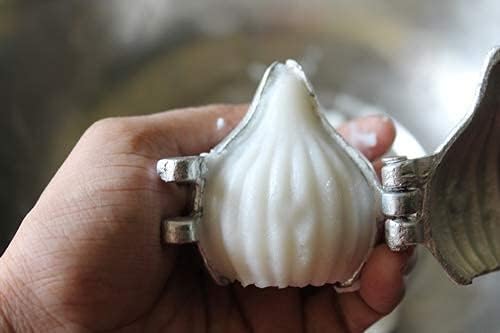 Pair of medium aluminum moulds shaping a white modak