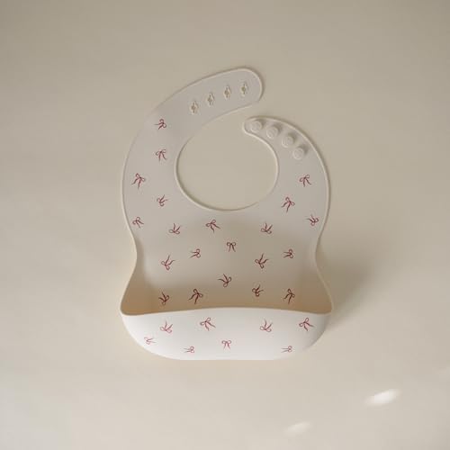 Image of mushie Silicone Baby Bib | Adjustable Fit Waterproof Bibs (Bows)