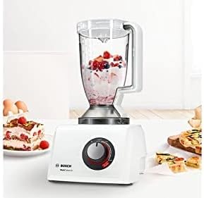 Blender attachment on the food processor base, blending a mixture of berries and cream